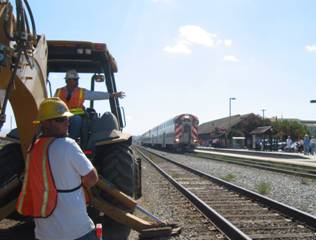 A train is on the tracks with workers.